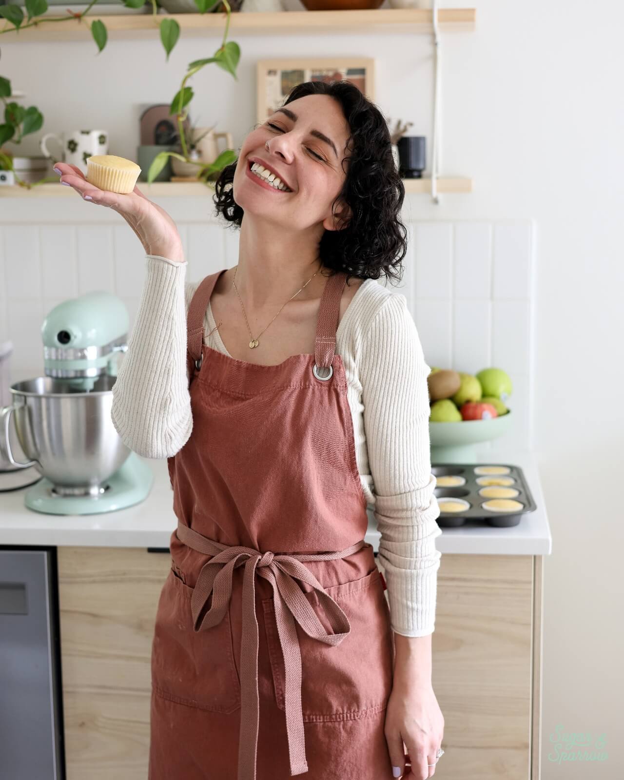 whitney depaoli from sugar & sparrow holding a cupcake