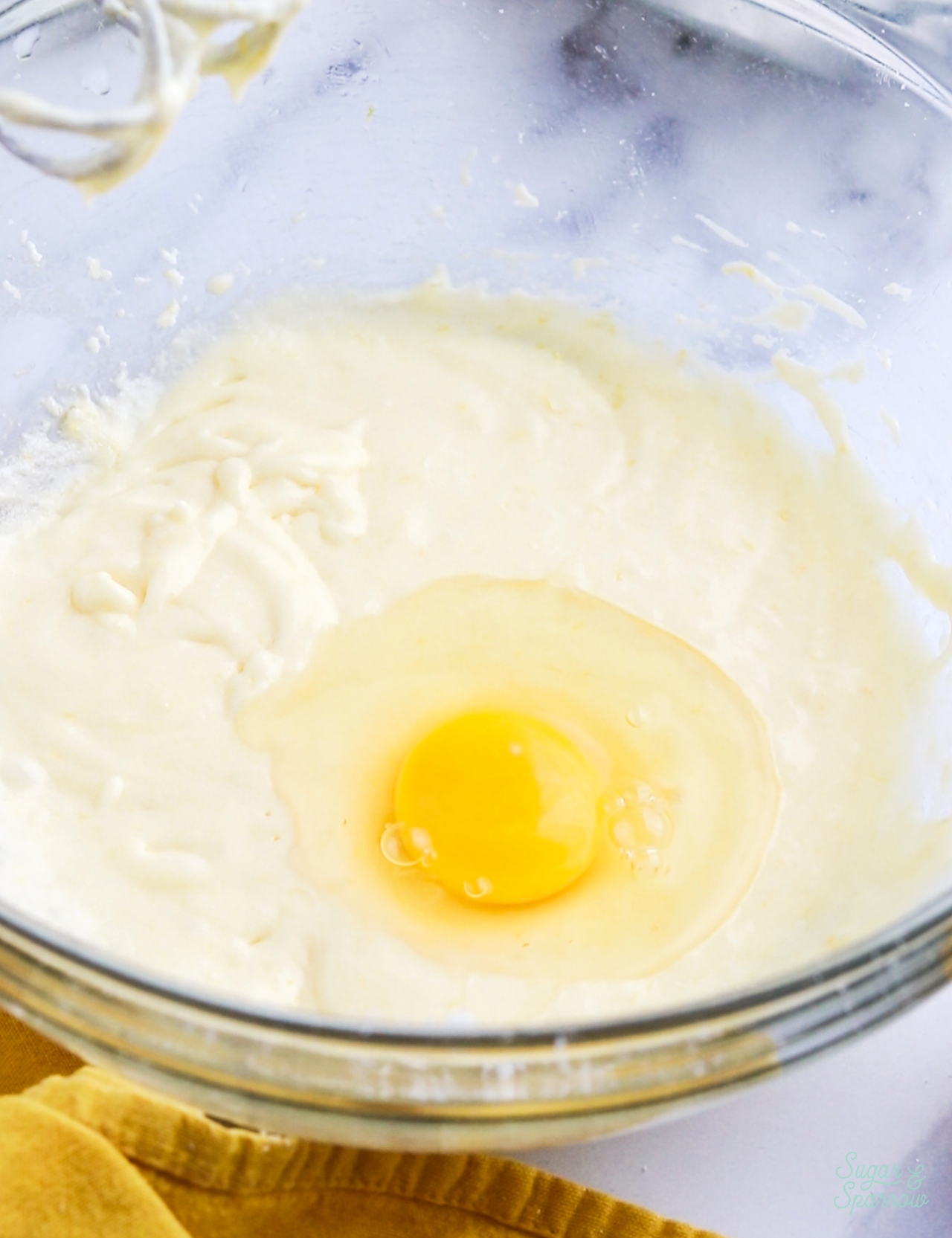 adding eggs to lemon cupcake batter