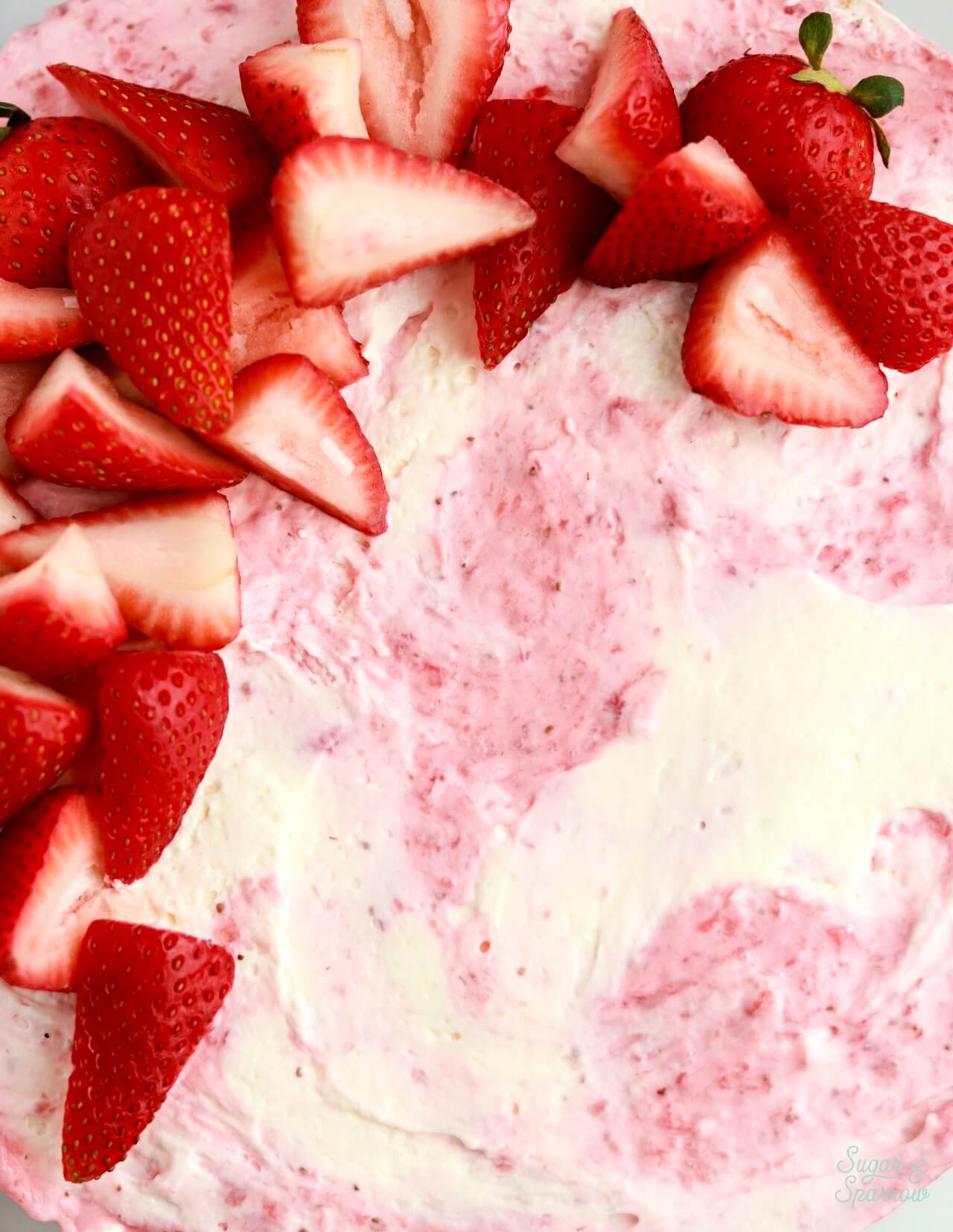 pink and white marbled cheesecake with strawberries on top