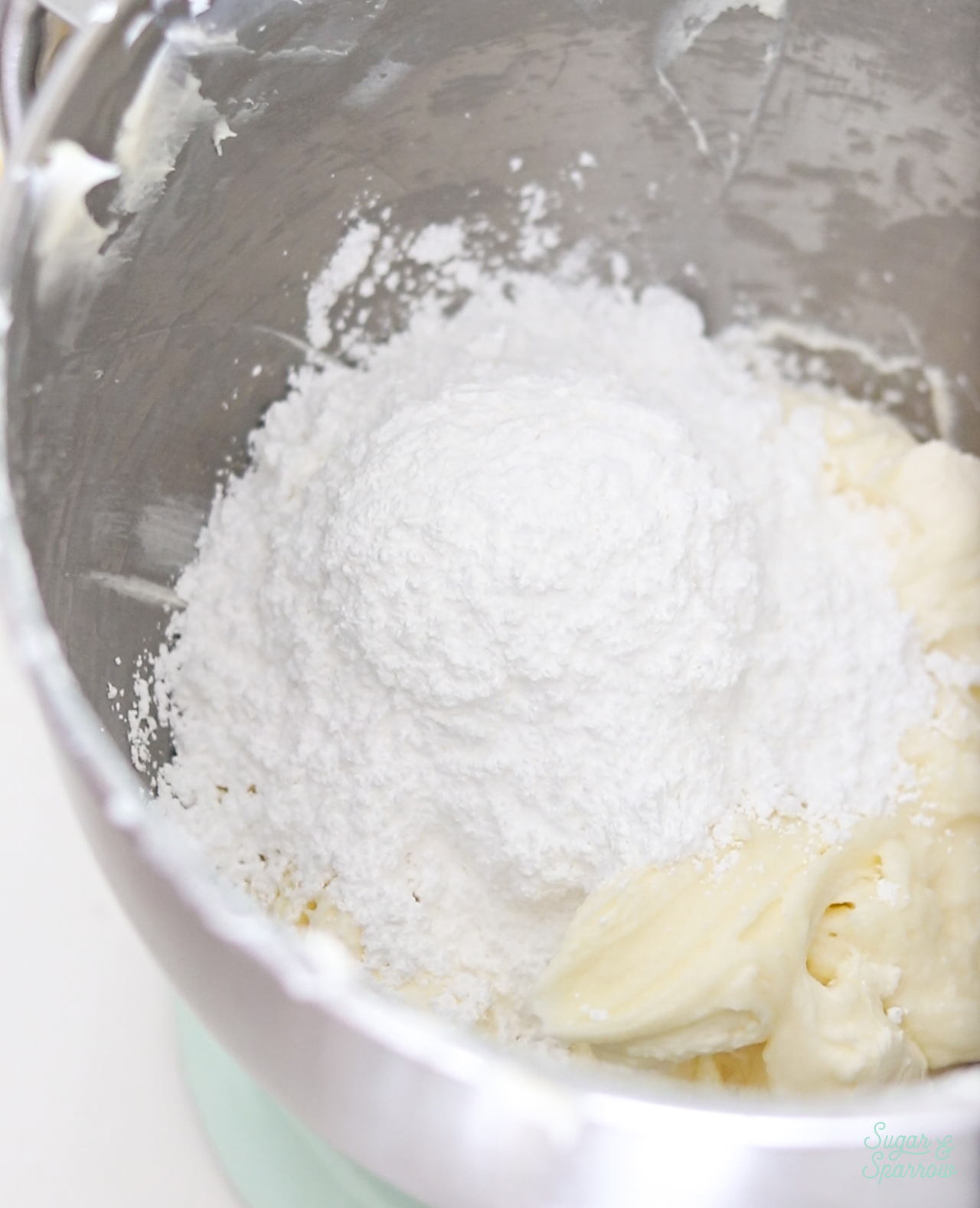 adding powdered sugar to cream cheese buttercream