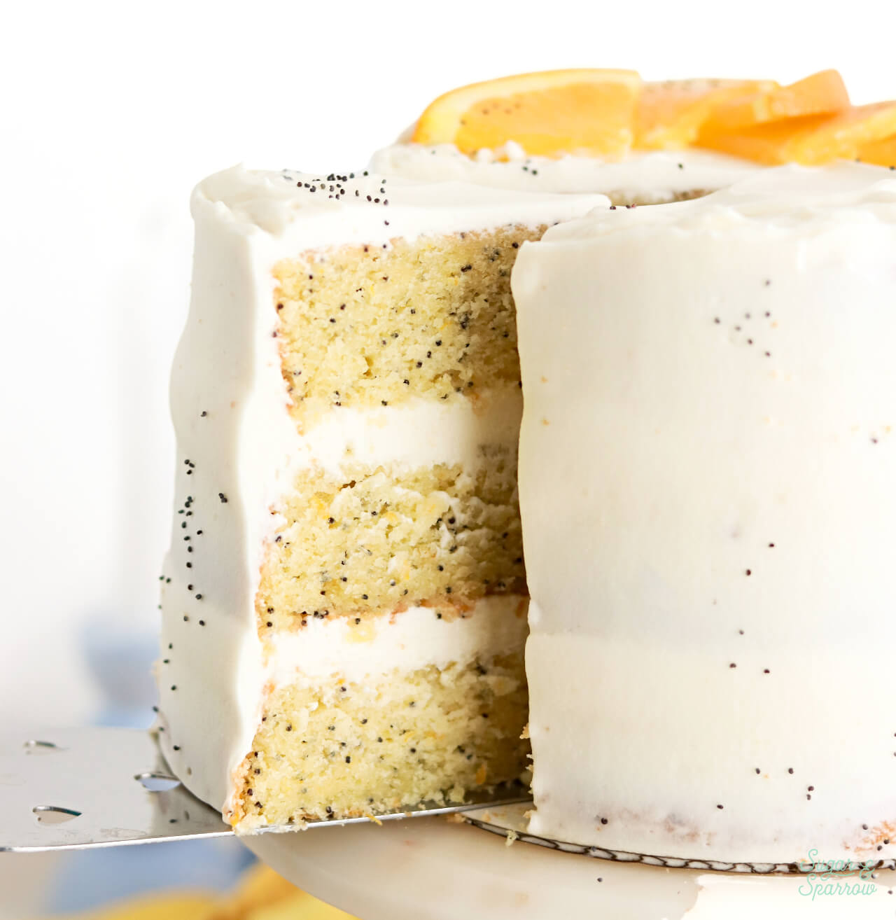 orange poppyseed cake slice with whipped mascarpone frosting 