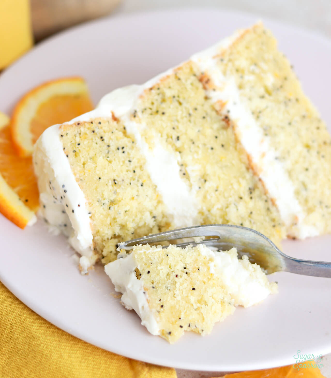 orange poppyseed cake slice on a plate