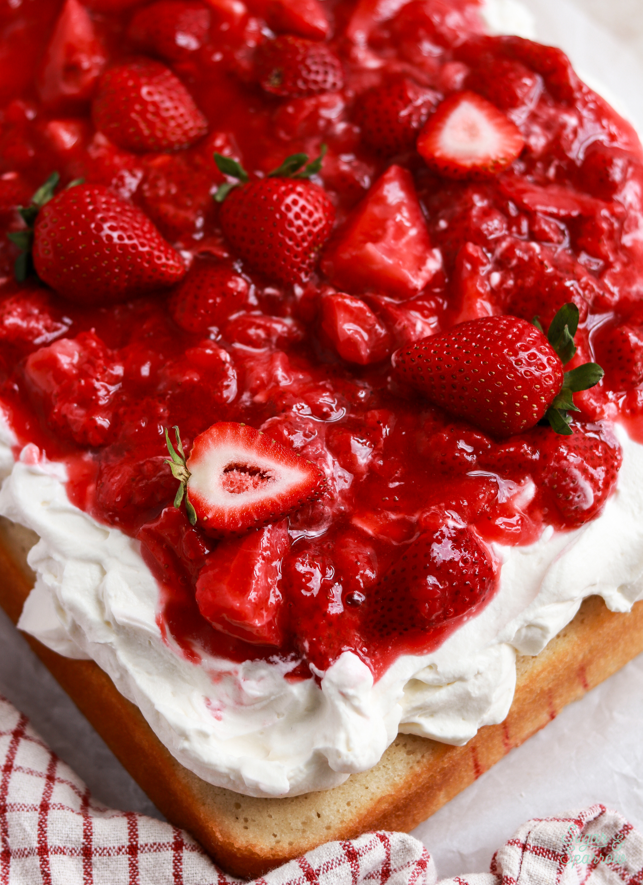 homemade strawberry sauce on top of strawberry shortcake cake