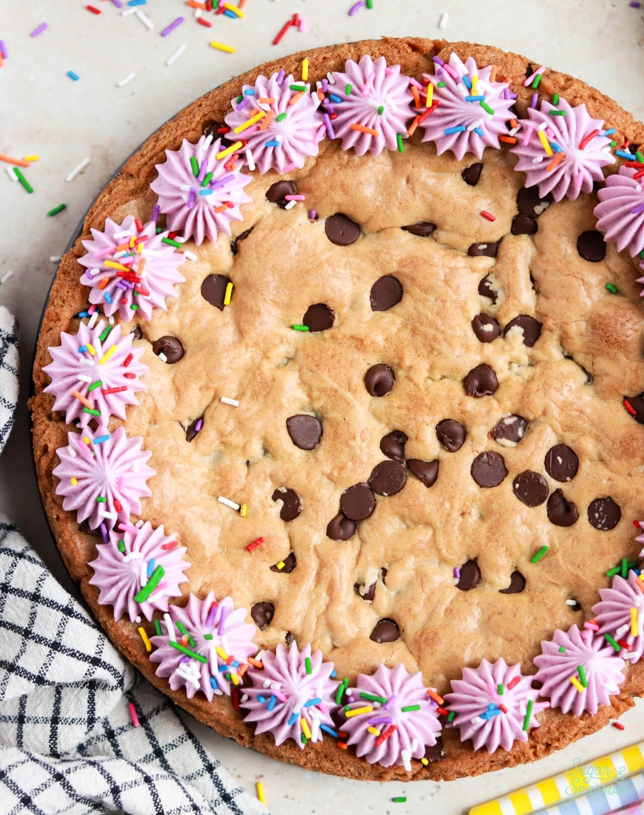 round chocolate chip cookie cake recipe decorated with buttercream