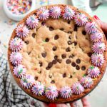 chocolate chip cookie cake recipe with vanilla buttercream border and sprinkles