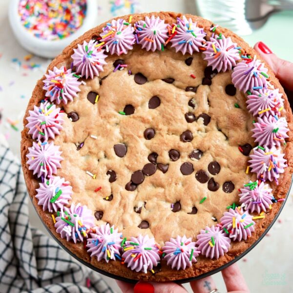 chocolate chip cookie cake recipe with vanilla buttercream border and sprinkles