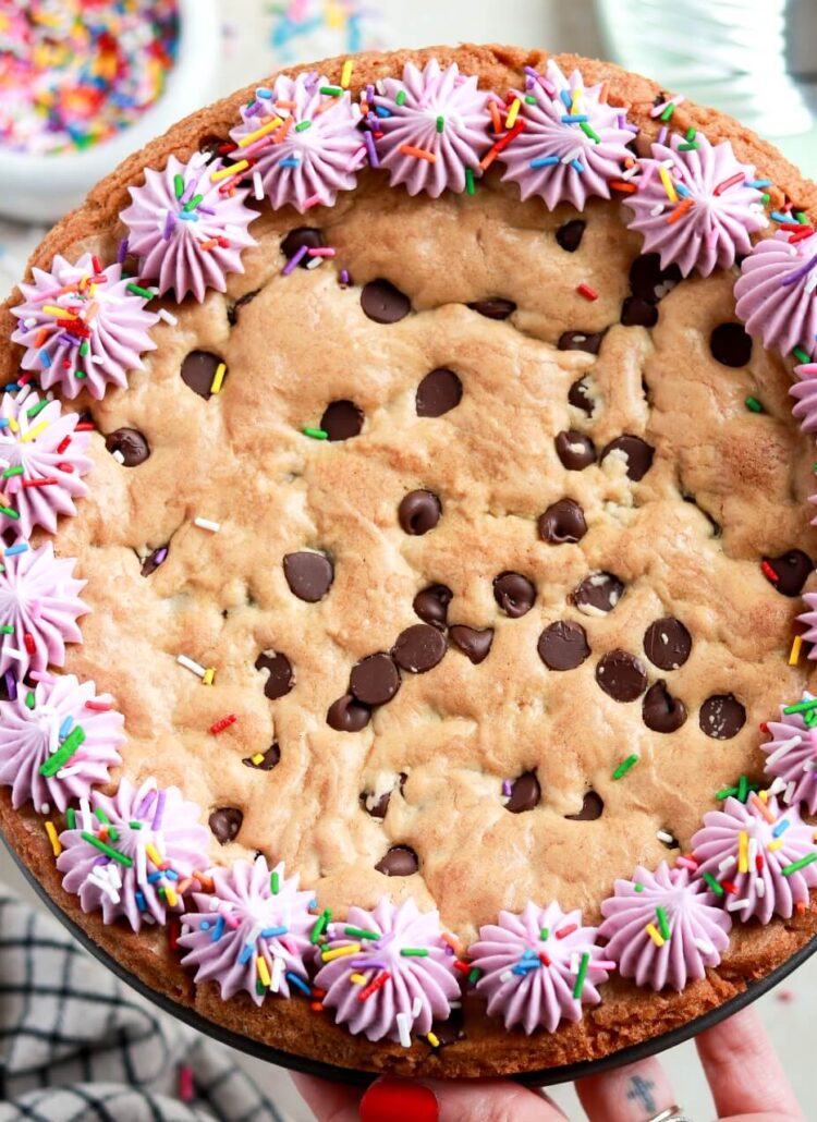 chocolate chip cookie cake recipe with vanilla buttercream border and sprinkles