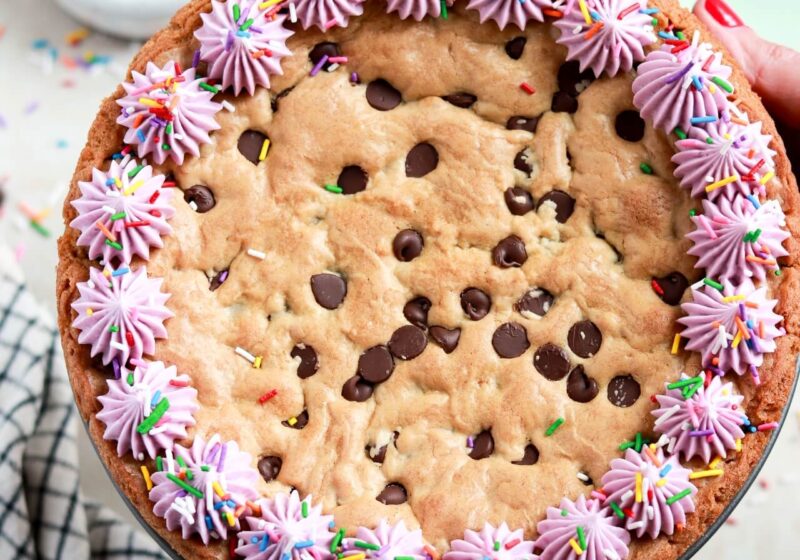 chocolate chip cookie cake recipe with vanilla buttercream border and sprinkles
