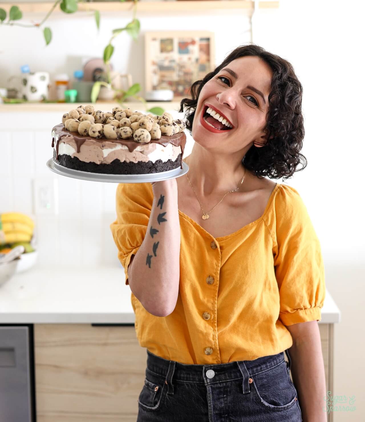 whitney depaoli of sugar and sparrow holding an ice cream cake