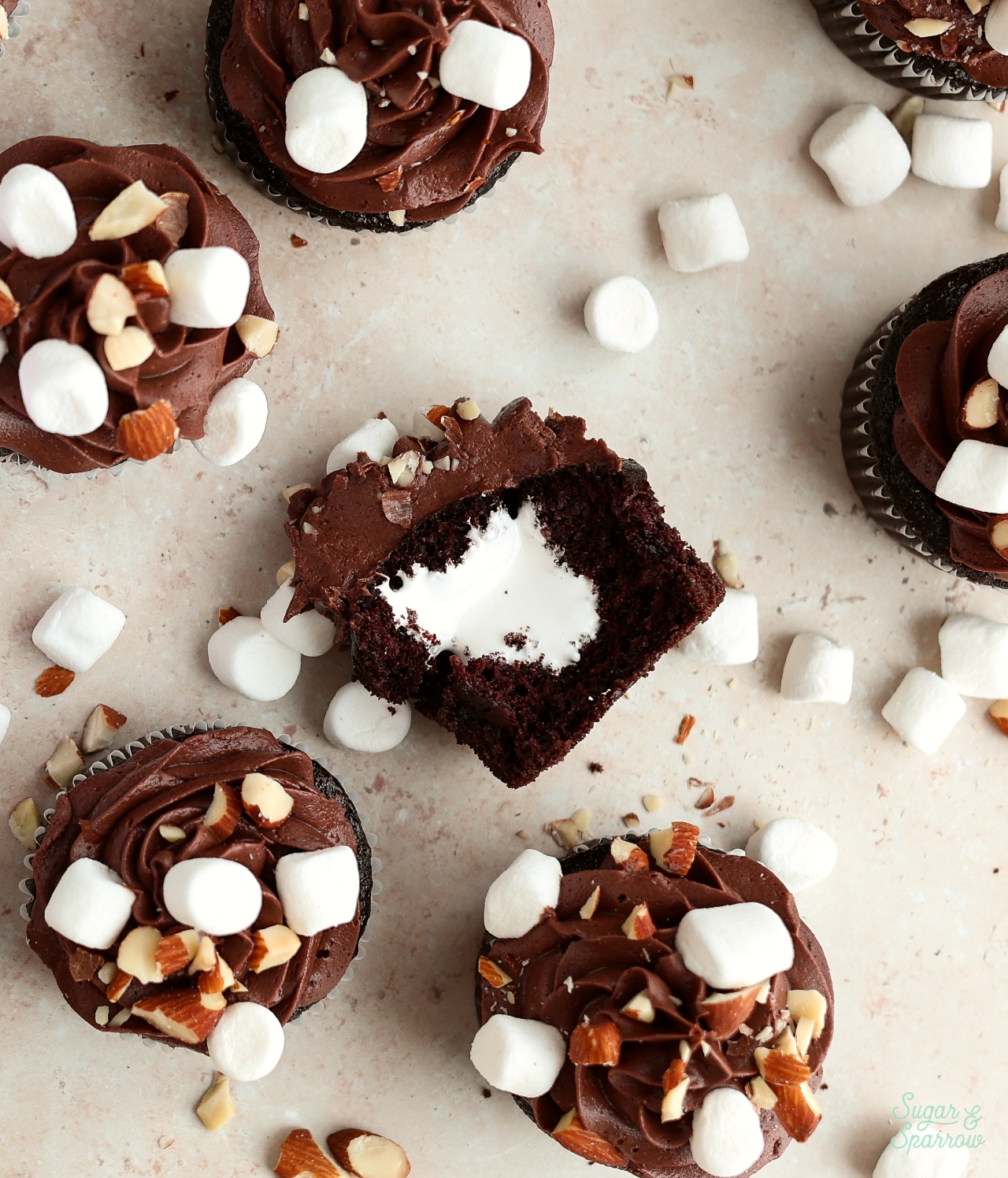 rocky road cupcakes with marshallow filling and chopped almonds