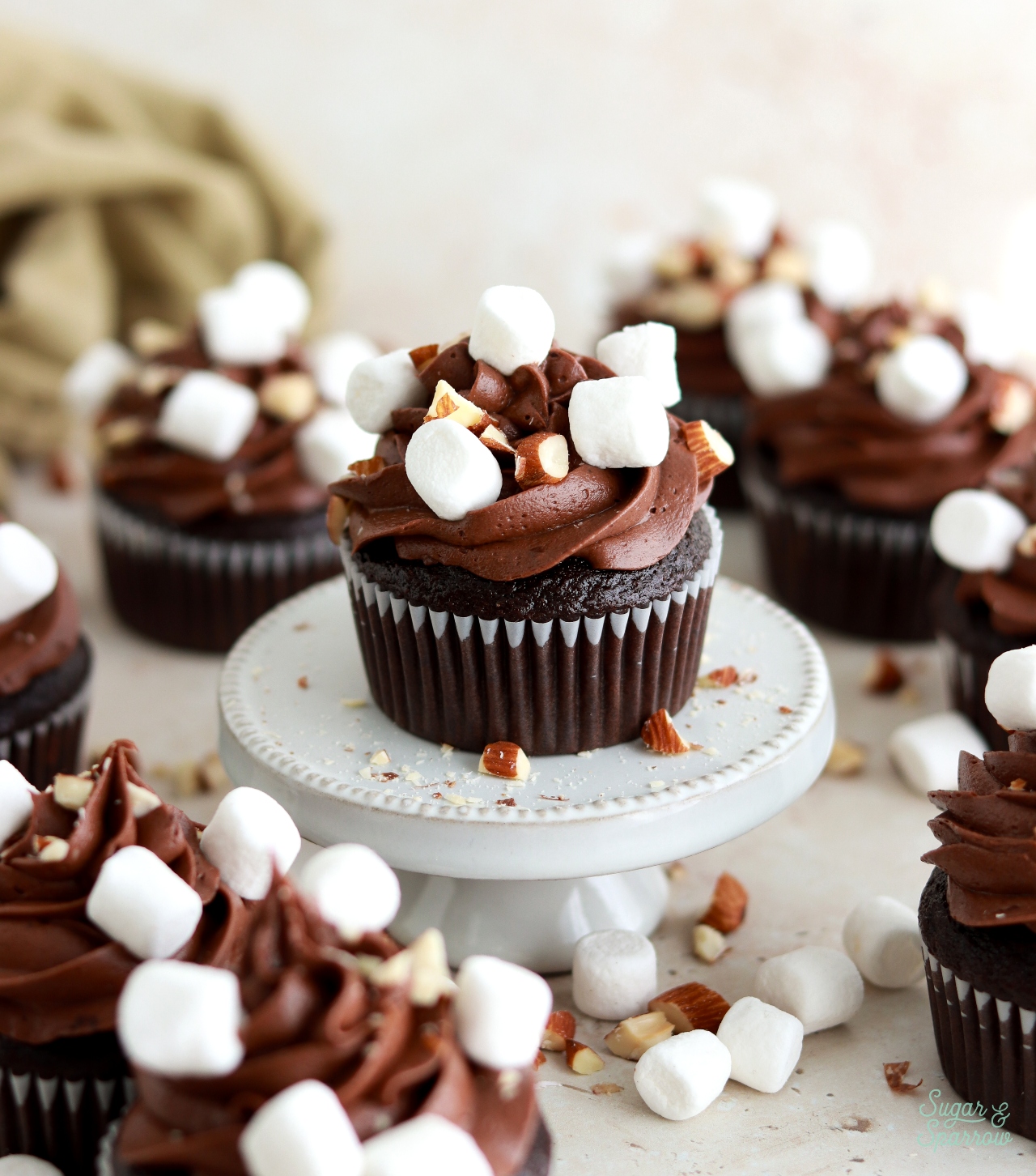 rocky road cupcakes with chopped almonds and mini marshmallows