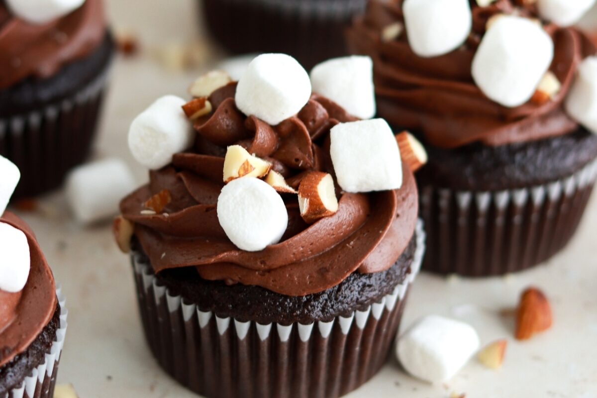 chocolate cupcakes with chocolate buttercream, marshmallow filling, mini marshmallows, and chopped almonds