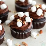 chocolate cupcakes with chocolate buttercream, marshmallow filling, mini marshmallows, and chopped almonds