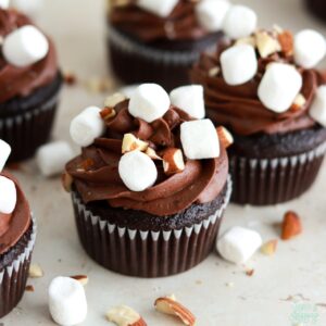 chocolate cupcakes with chocolate buttercream, marshmallow filling, mini marshmallows, and chopped almonds
