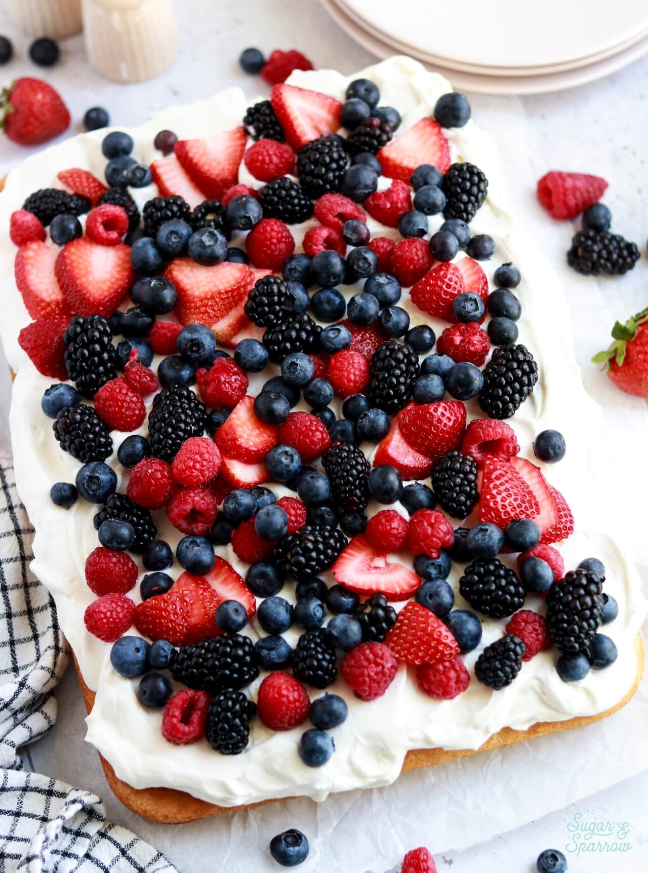 vanilla sheet cake with whipped cream frosting and fresh berries