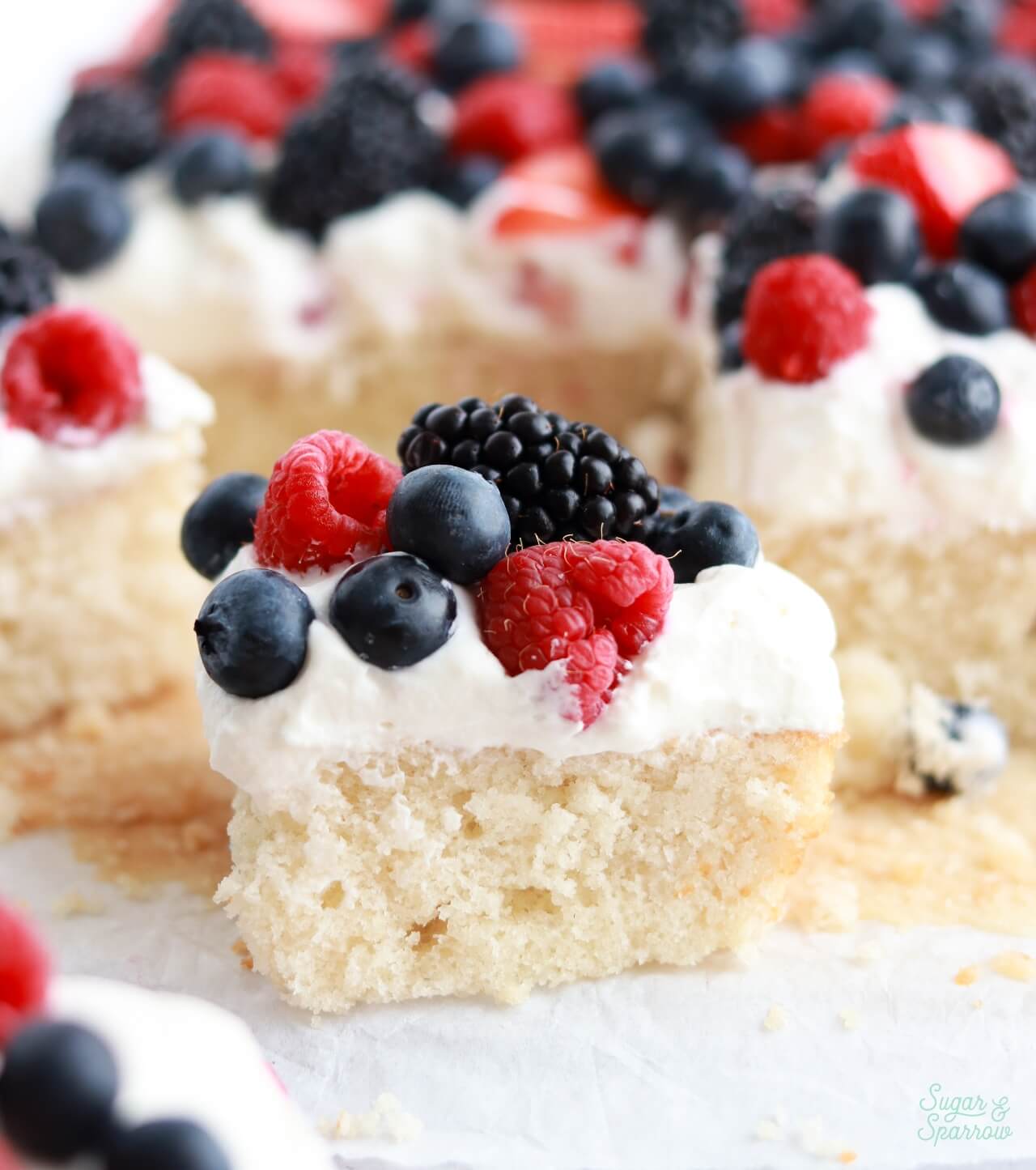vanilla sheet cake with fresh summer berries and whipped cream frosting