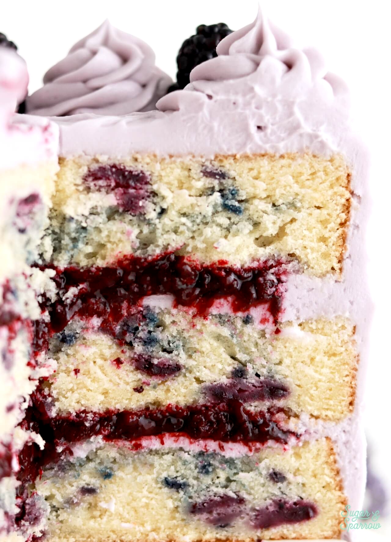 layers of blackberry cake, blackberry cake filling, and lavender buttercream