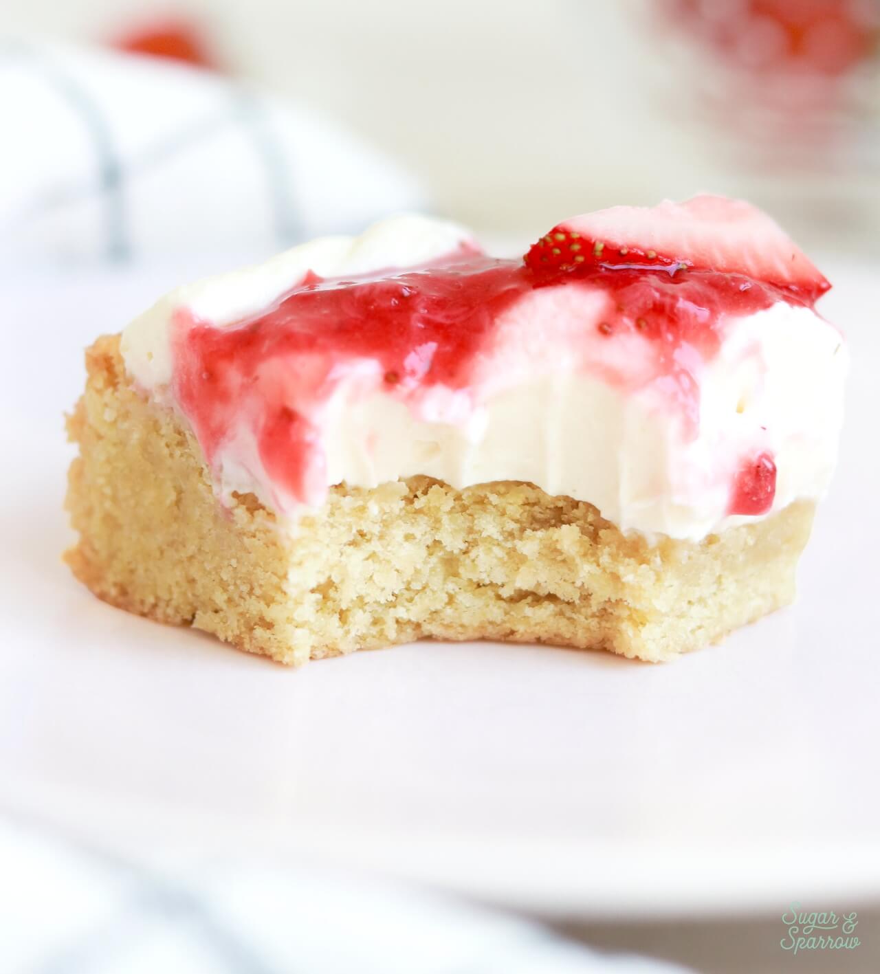 soft and chewy sugar cookie bars with strawberry shortcake toppings