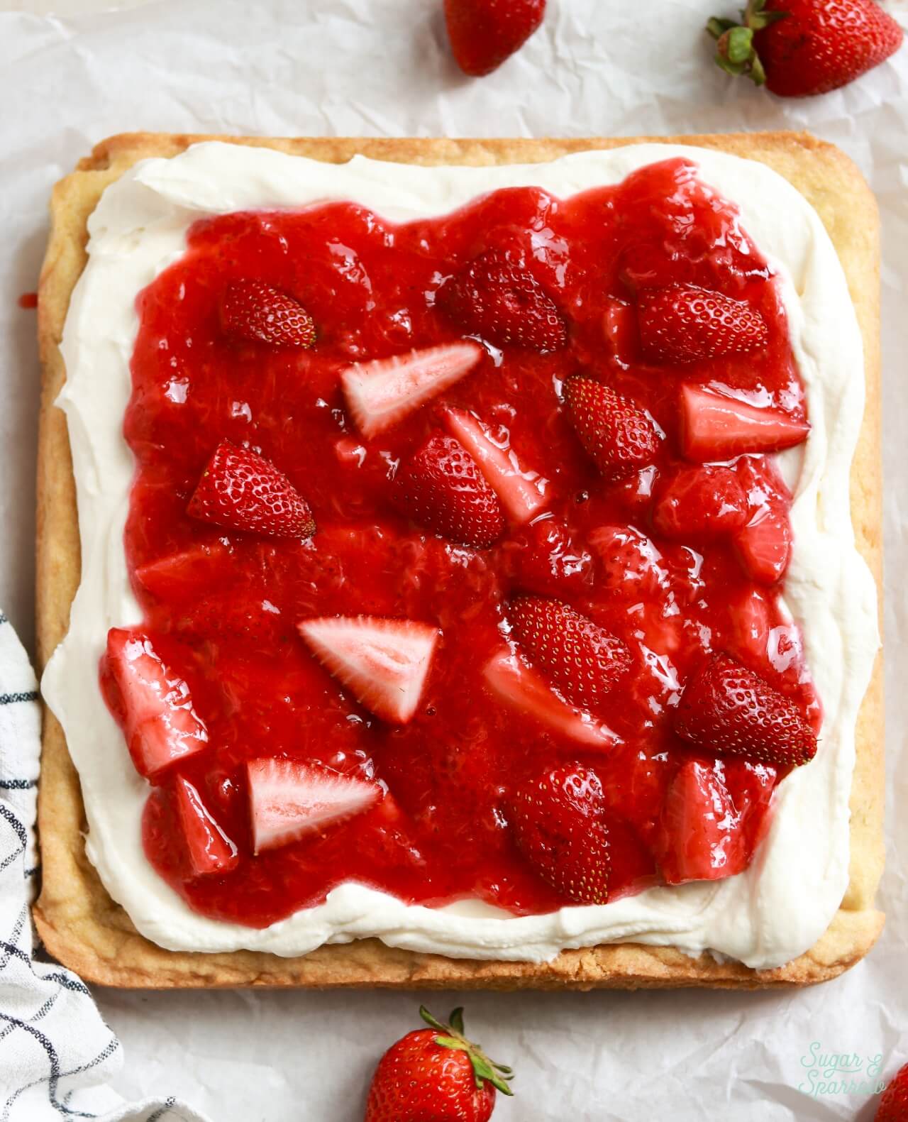 strawberry shortcake sugar cookie bars with homemade strawberry sauce