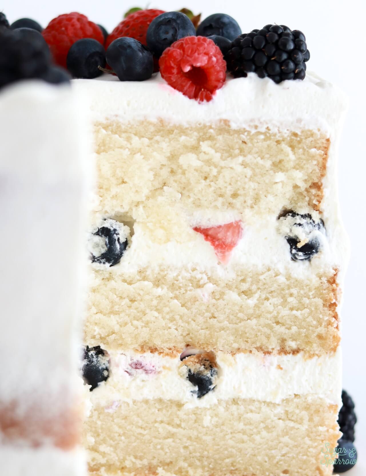 berries and cream layer cake with whipped cream frosting