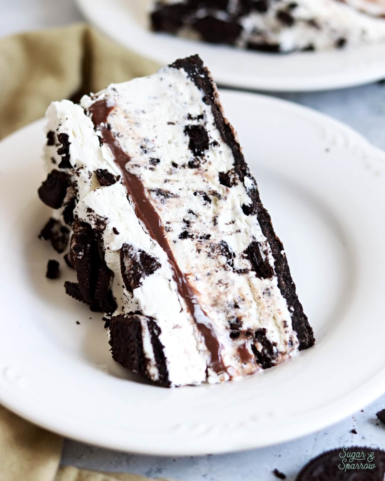 no-churn oreo ice cream cake with oreo cookie crust sliced on a plate