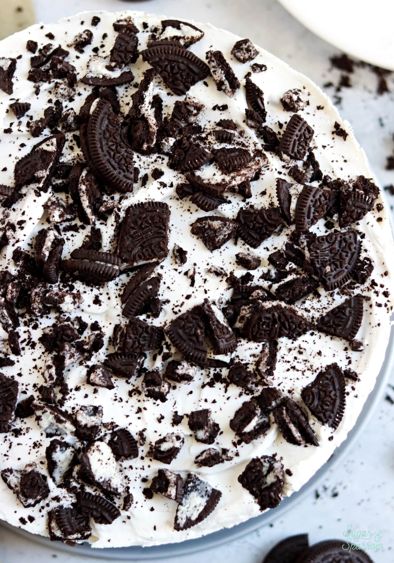 chopped oreos on top of ice cream cake