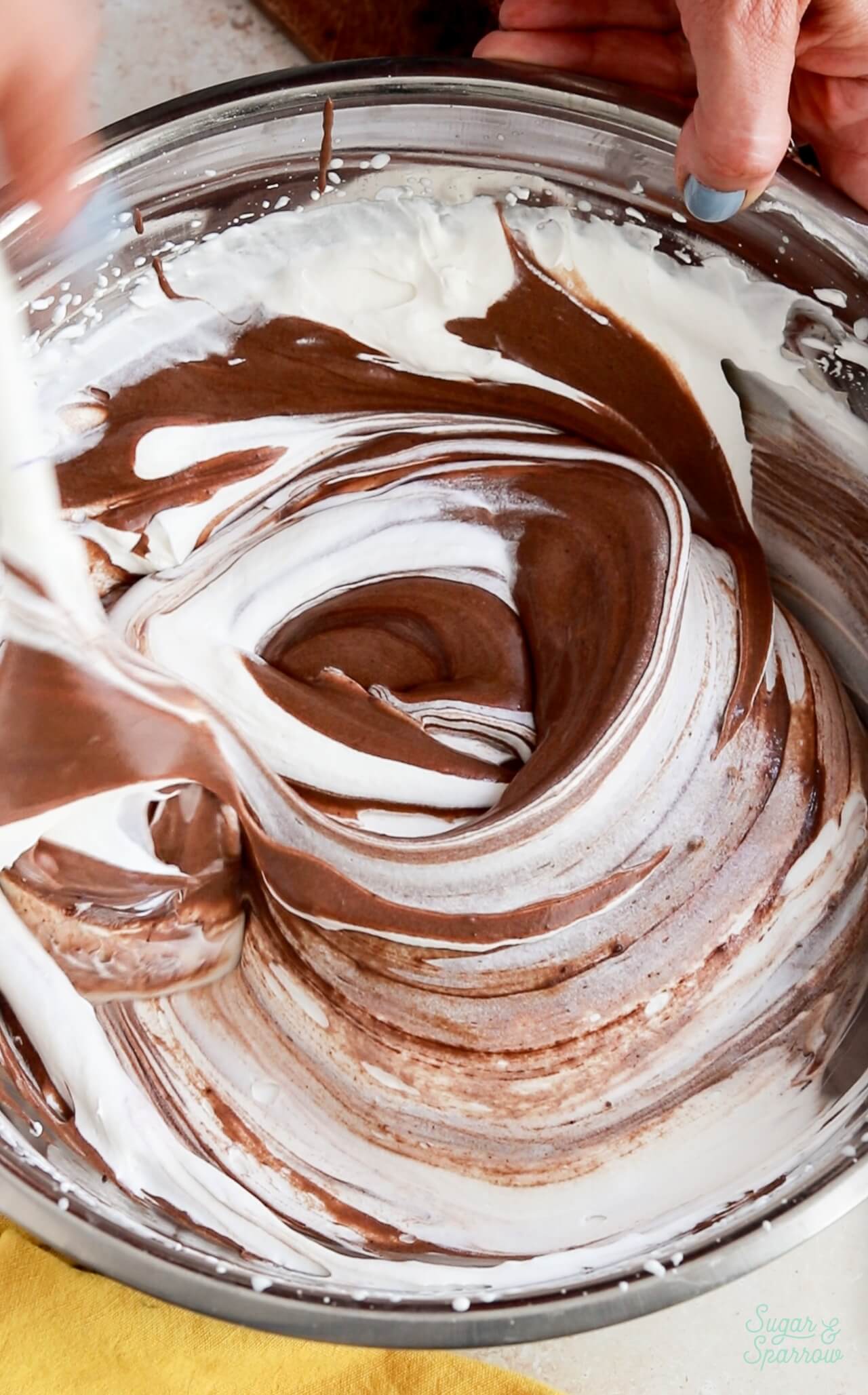 folding chocolate condensed milk mixture into heavy whipping cream for no-churn ice cream