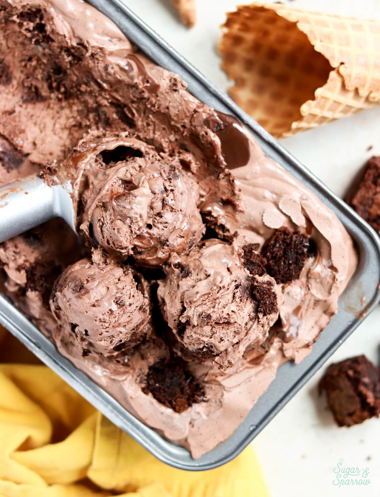 no churn chocolate brownie ice cream scoops in a loaf pan