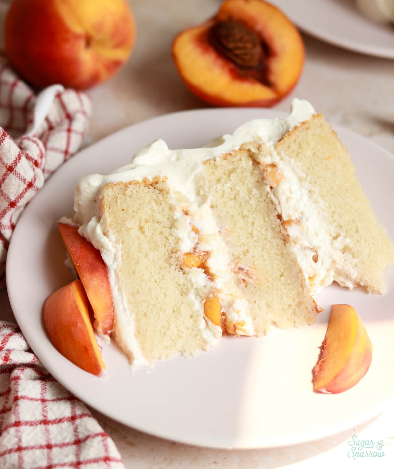 peaches and cream cake slice on a plate