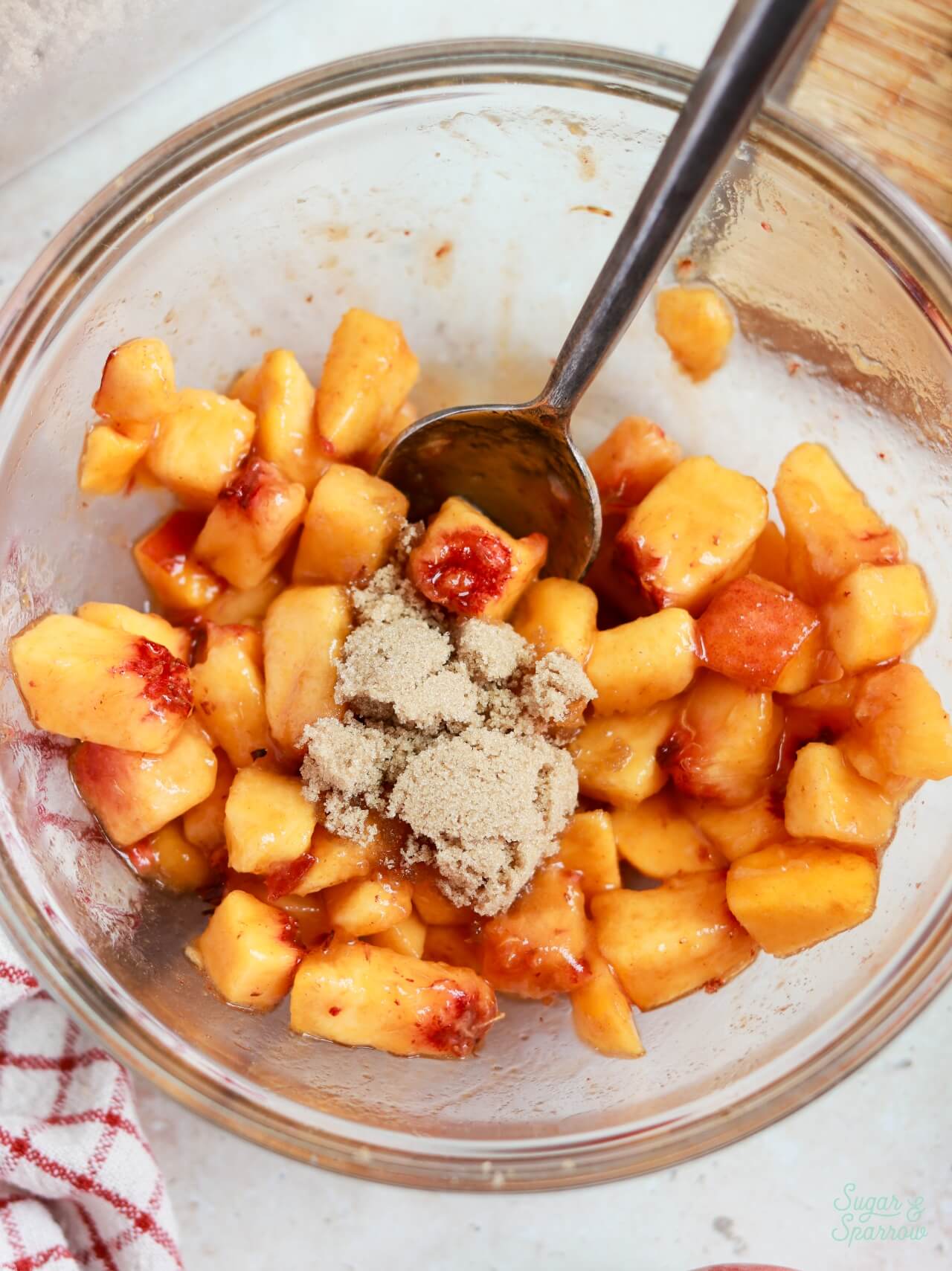 combining brown sugar with fresh peaches