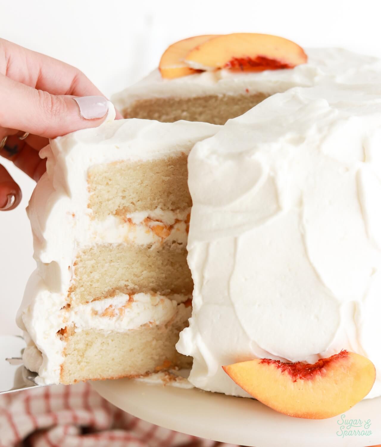 slicing peaches and cream layer cake