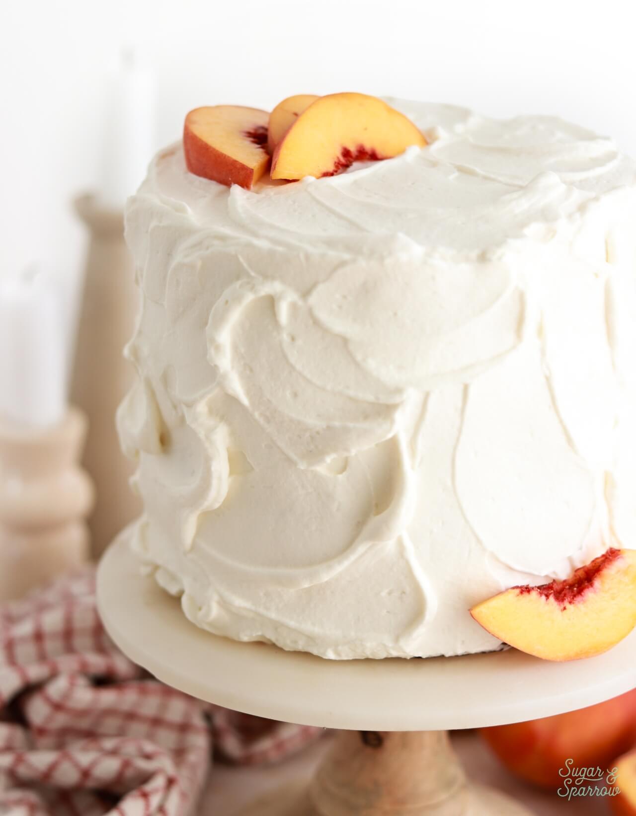 peaches and cream layer cake frosted with whipped cream frosting