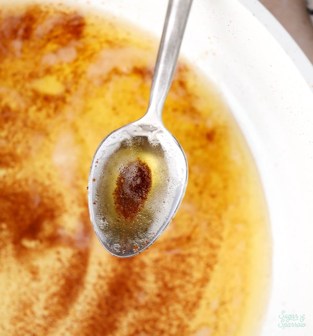 holding a spoonful of brown butter