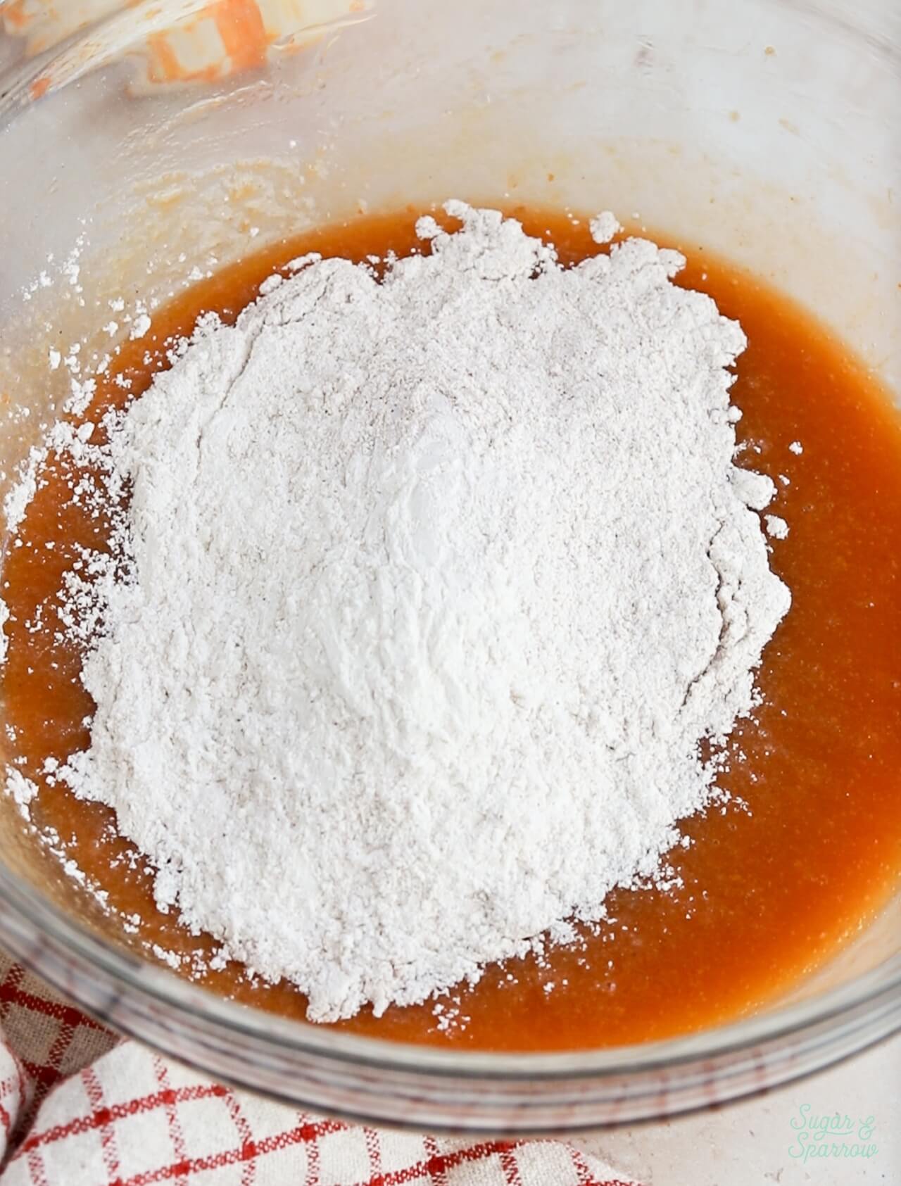 Add dry ingredients to wet ingredients in pumpkin cake recipe
