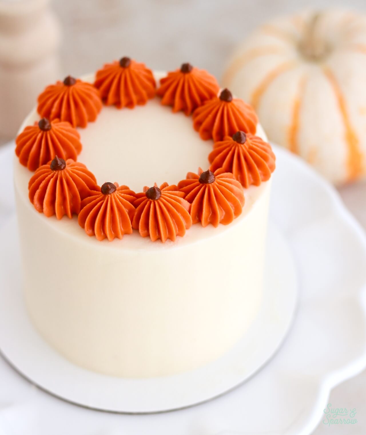 small batch pumpkin cake with buttercream pumpkins on top