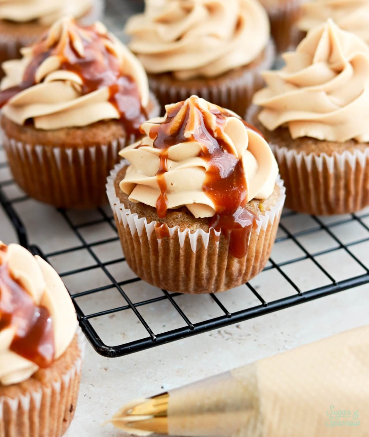 apple cupcakes topped with caramel buttercream and salted caramel sauce