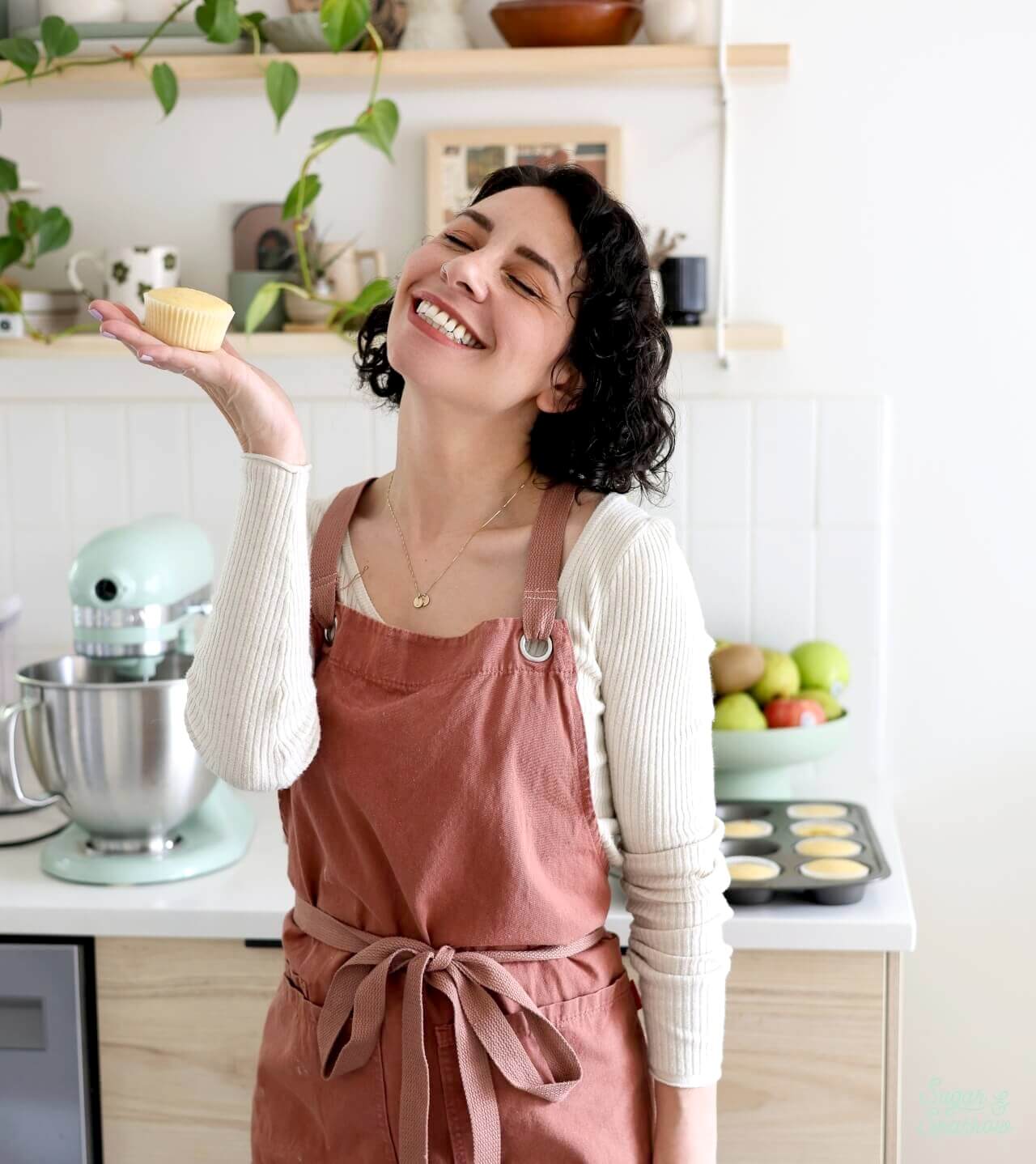 Whitney DePaoli of Sugar and Sparrow holding a cupcake